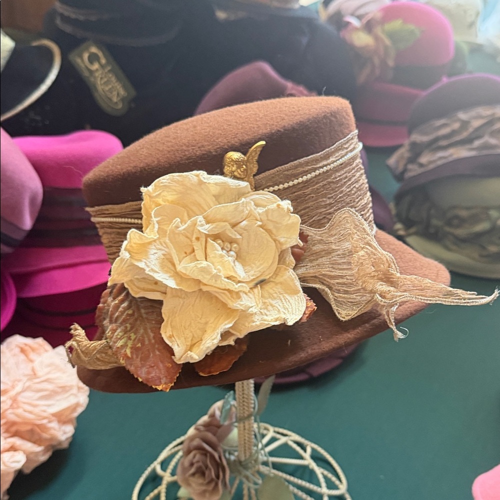 Elegant Brown Hat with Cream Floral Accent